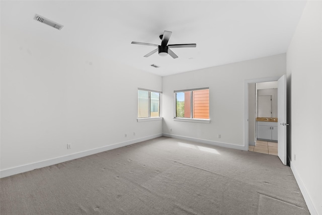 4406 Spencer St Unit A, Houston, TX 77007 - spare room with light carpet, a ceiling fan, and baseboards