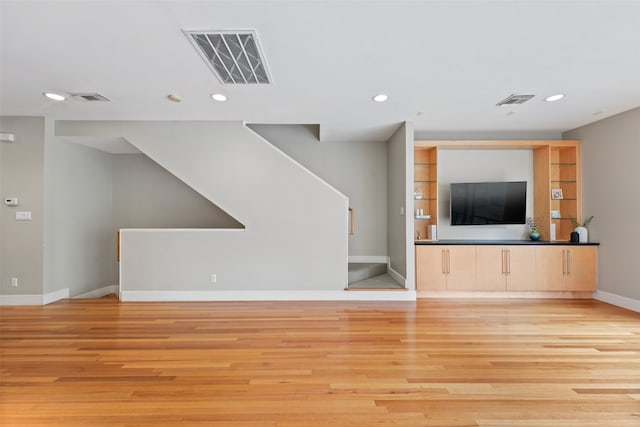 4406 Spencer St Unit A, Houston, TX 77007 - unfurnished living room with recessed lighting, baseboards, light wood finished floors, and stairway