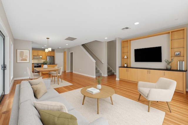 4406 Spencer St Unit A, Houston, TX 77007 - living room with stairway, light wood-style flooring, baseboards, and recessed lighting