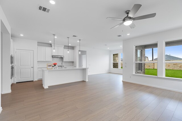 28810 Copper Ridge Dr, Fulshear, TX 77441 - unfurnished living room featuring recessed lighting, light wood finished floors, and a ceiling fan