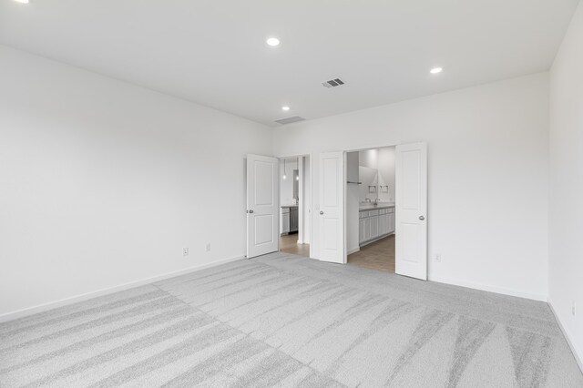 28810 Copper Ridge Dr, Fulshear, TX 77441 - unfurnished bedroom featuring light carpet, recessed lighting, and ensuite bathroom