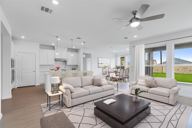 28810 Copper Ridge Dr, Fulshear, TX 77441 - living area with light wood finished floors, recessed lighting, and a ceiling fan