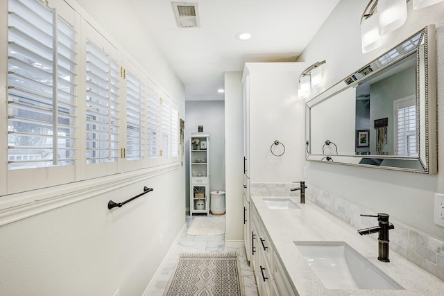 2227 Hialeah Dr, Houston, TX 77018 - bathroom featuring visible vents, a sink, recessed lighting, and marble finish floor