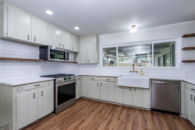 2007 Lamonte Ln, Houston, TX 77018 - kitchen with stainless steel appliances, open shelves, tasteful backsplash, light countertops, and ornamental molding