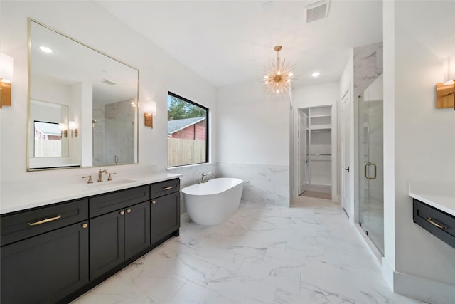 1905 Norcrest Dr, Houston, TX 77055 - bathroom featuring a shower stall, marble finish floors, vanity, a freestanding bath, and recessed lighting