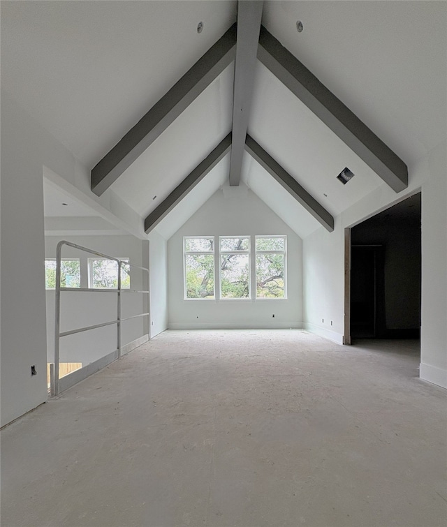 unfurnished living room featuring vaulted ceiling with beams