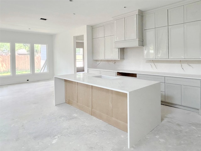 1905 Norcrest Dr, Houston, TX 77055 - kitchen with unfinished concrete floors, a center island, and light countertops