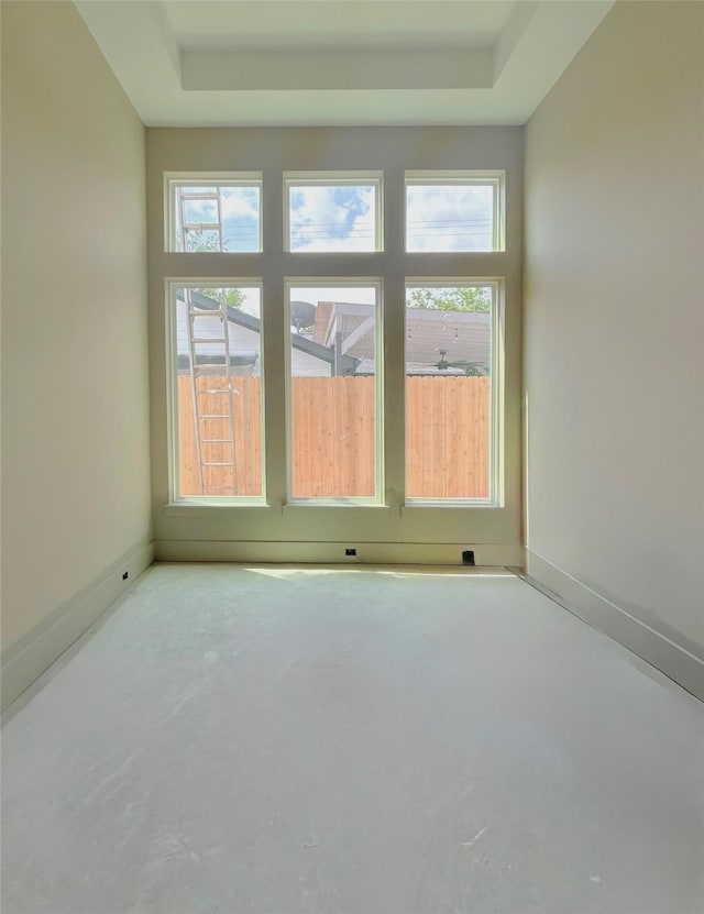 1905 Norcrest Dr, Houston, TX 77055 - empty room featuring a tray ceiling, baseboards, and concrete floors