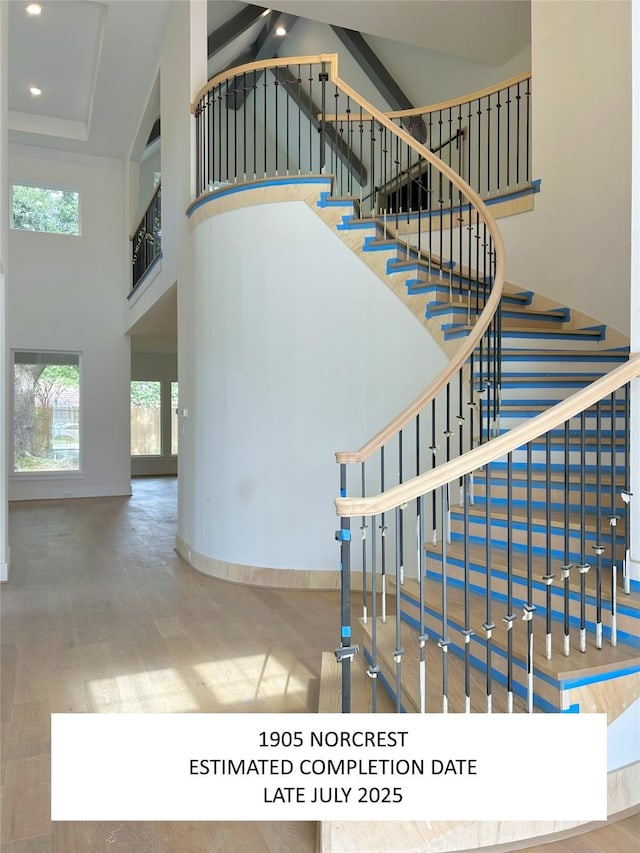 1905 Norcrest Dr, Houston, TX 77055 - stairs featuring a towering ceiling, wood finished floors, and recessed lighting
