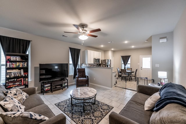 25843 Hickory Pecan Trl, Tomball, TX 77375 - living room featuring a ceiling fan, light tile patterned flooring, baseboards, and recessed lighting