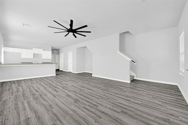 13218 Hp Johnson St A/B, Unit A/B Kendleton, TX 77451 - unfurnished living room featuring visible vents, baseboards, stairs, wood finished floors, and a ceiling fan