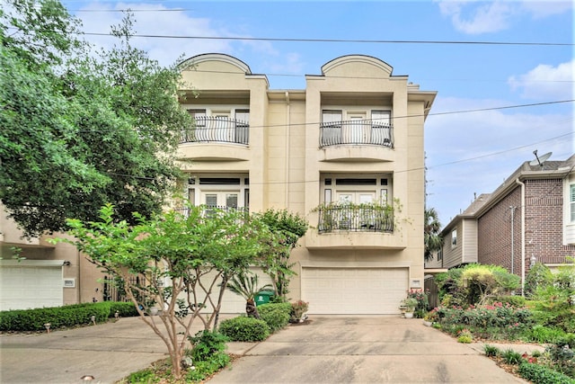 view of front of property featuring a garage, stucco siding, and concrete driveway