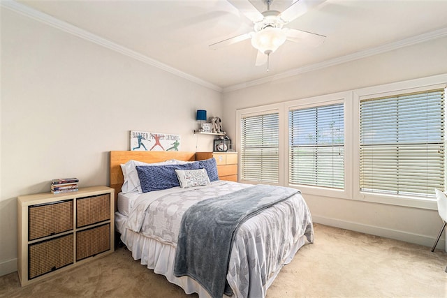 carpeted bedroom featuring crown molding, baseboards, and a ceiling fan