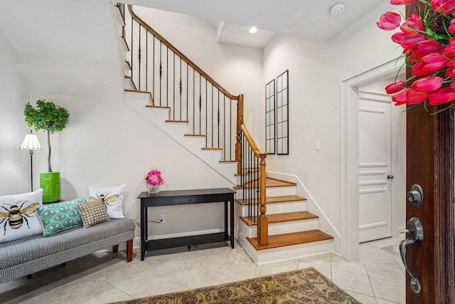 entryway featuring tile patterned floors, recessed lighting, baseboards, and stairs