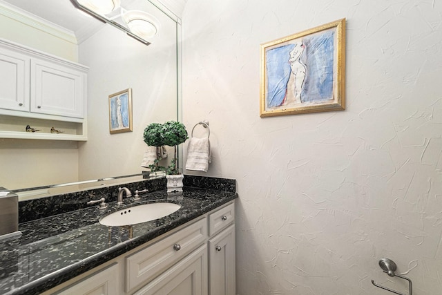 bathroom featuring crown molding and vanity