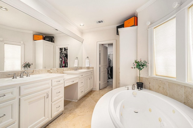 bathroom with vanity, ornamental molding, visible vents, a healthy amount of sunlight, and a tub with jets