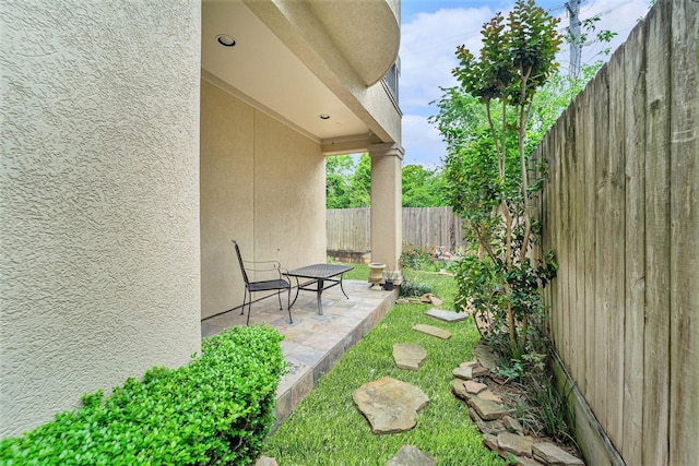 view of yard featuring a patio area and a fenced backyard