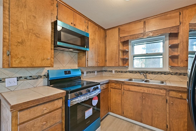 kitchen featuring brown cabinetry, open shelves, a sink, electric stove, and backsplash