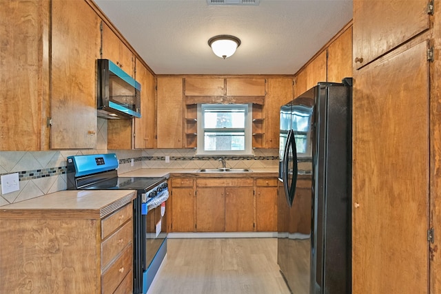 kitchen featuring open shelves, black fridge with ice dispenser, brown cabinets, a sink, and electric stove