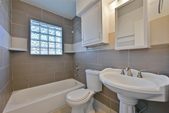 full bathroom featuring shower / bathtub combination, toilet, tile walls, and a sink