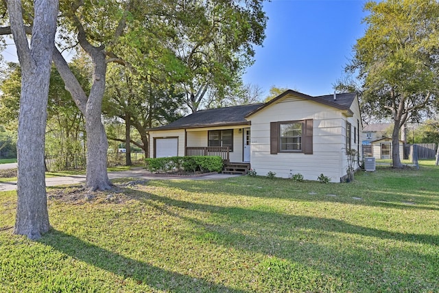 view of front facade featuring a garage, covered porch, and a front lawn