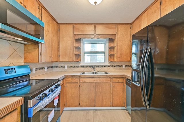 kitchen with open shelves, stainless steel electric stove, tasteful backsplash, a sink, and black fridge