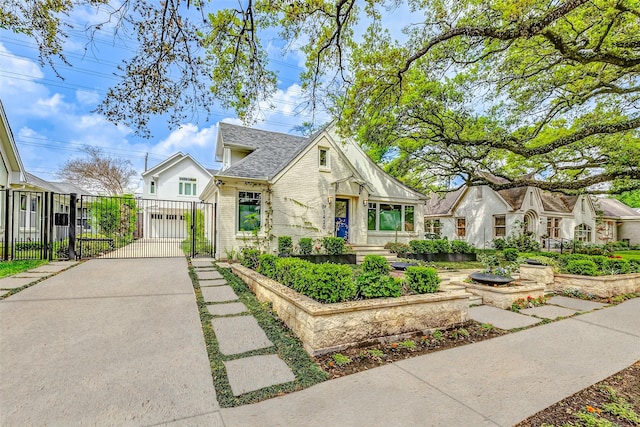 1420 Vassar St, Houston, TX 77006 - view of front of home with a gate, driveway, fence, a garage, and brick siding