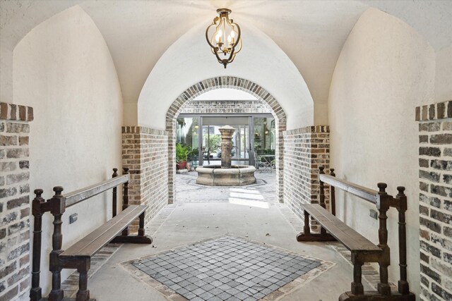 2222 Oxford St, Houston, TX 77008 - hall featuring arched walkways, brick wall, and lofted ceiling