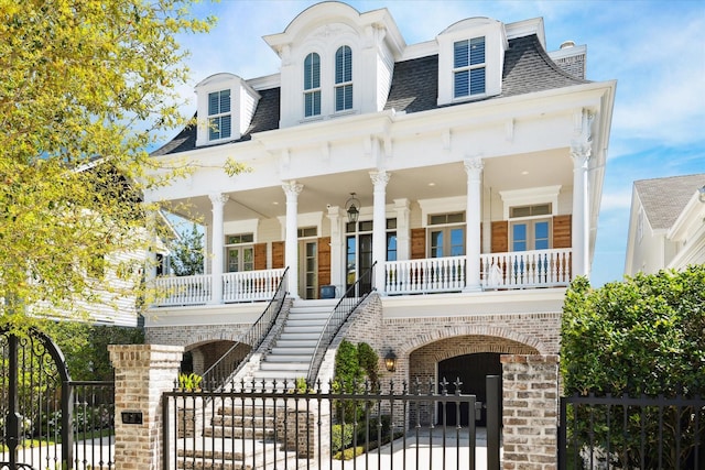 2222 Oxford St, Houston, TX 77008 - view of front of house featuring a gate, stairway, roof with shingles, a fenced front yard, and a porch