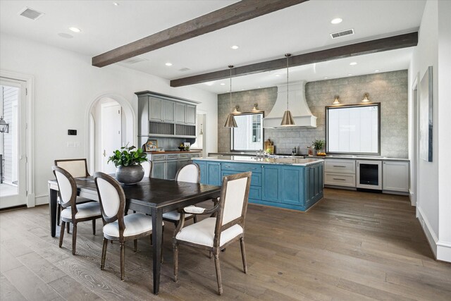 2222 Oxford St, Houston, TX 77008 - dining area featuring beamed ceiling, visible vents, wine cooler, and dark wood-style flooring