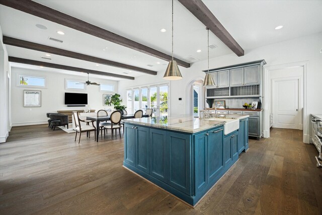 2222 Oxford St, Houston, TX 77008 - kitchen with blue cabinets, dark wood-type flooring, a sink, arched walkways, and a ceiling fan