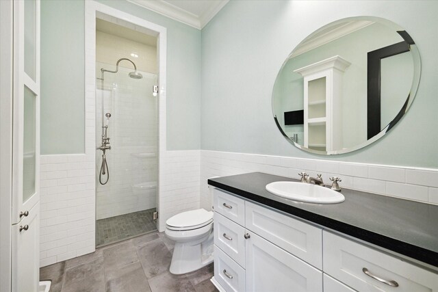 2222 Oxford St, Houston, TX 77008 - full bath featuring tile walls, a shower stall, ornamental molding, toilet, and wainscoting