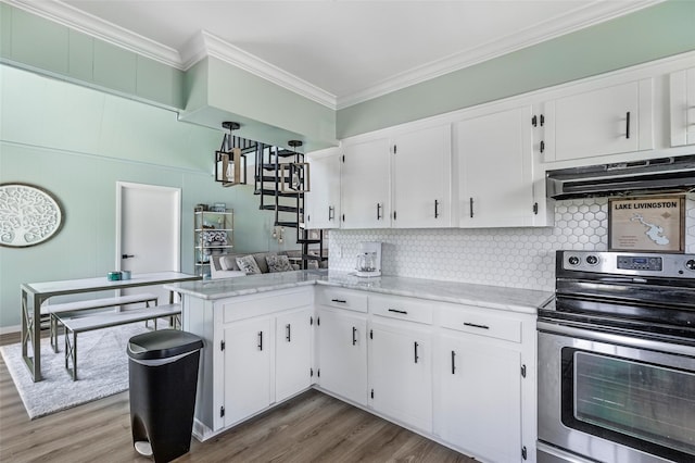 kitchen with stainless steel electric range oven, tasteful backsplash, white cabinets, ornamental molding, and extractor fan