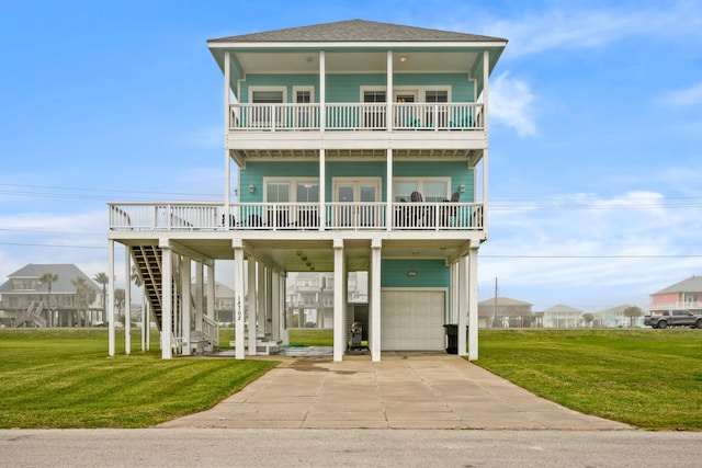 view of front facade featuring a carport, a balcony, a front yard, and a garage