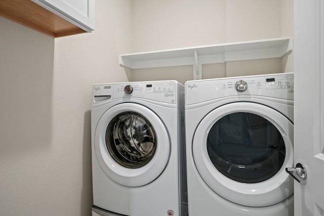 laundry room with cabinet space and washer and dryer