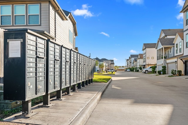 view of road featuring a residential view and curbs