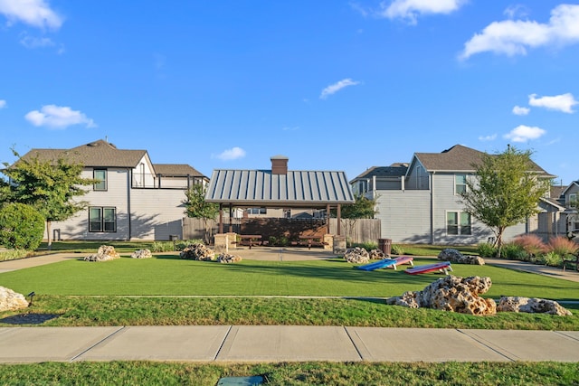 view of community featuring a residential view and a lawn