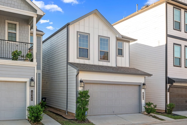 view of front of home with driveway, a garage, board and batten siding, and roof with shingles