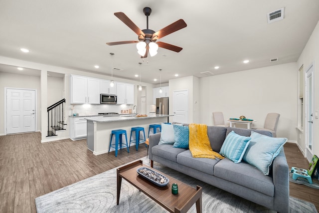 living room with visible vents, wood finished floors, recessed lighting, and a ceiling fan