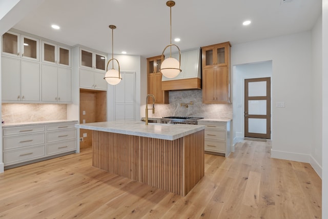 kitchen featuring decorative backsplash, light wood finished floors, and recessed lighting