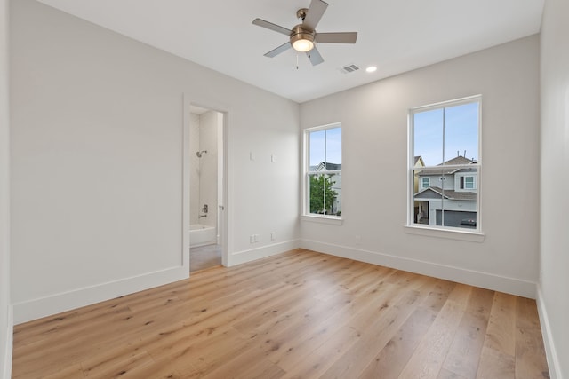 unfurnished room featuring recessed lighting, baseboards, visible vents, and light wood-type flooring
