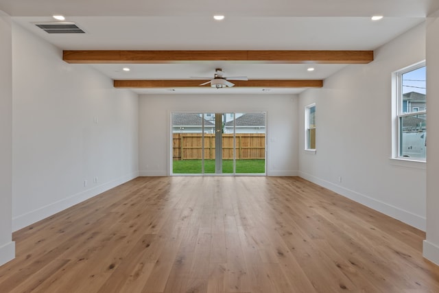 spare room with baseboards, visible vents, light wood-style floors, and a healthy amount of sunlight