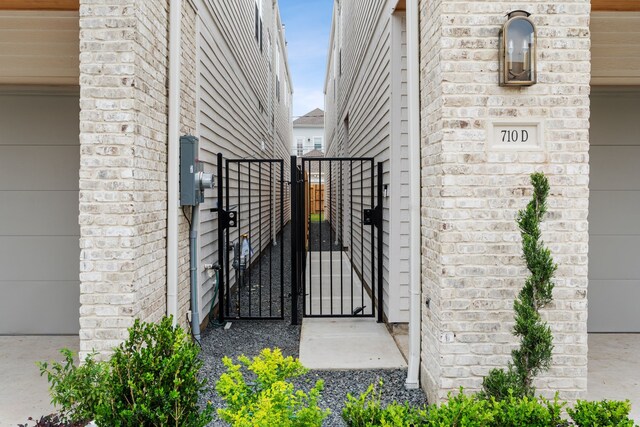 view of side of home with a gate