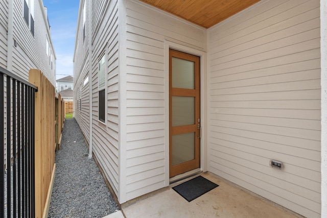 doorway to property featuring fence