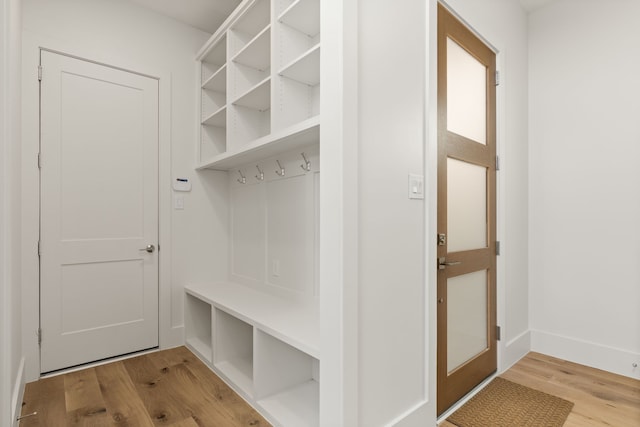 mudroom with wood finished floors and baseboards