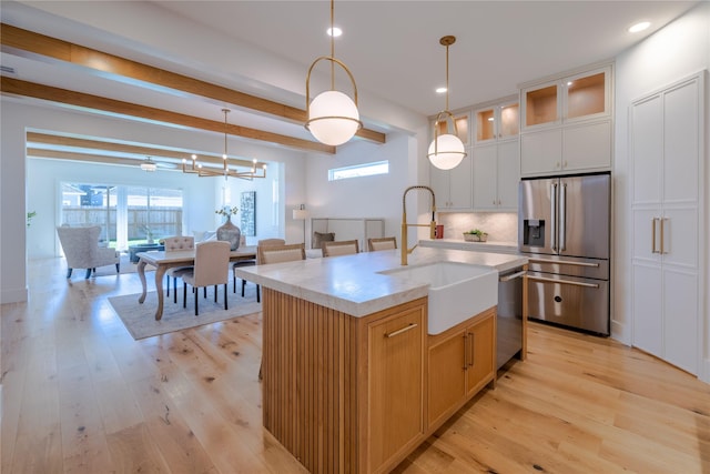 710 Waverly St Unit D, Houston, TX 77007 - kitchen featuring stainless steel appliances, healthy amount of natural light, light wood-style flooring, and recessed lighting