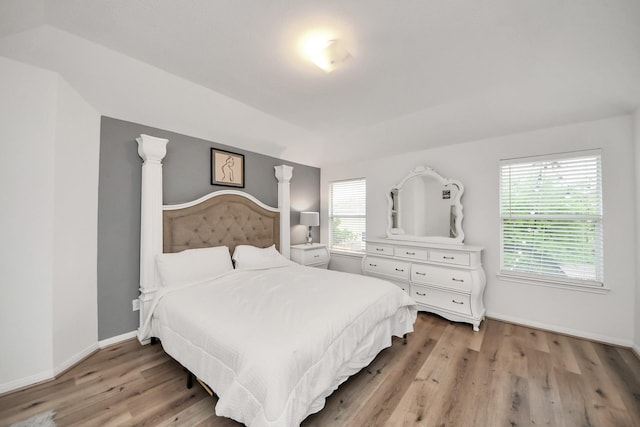 bedroom featuring baseboards and light wood-style flooring