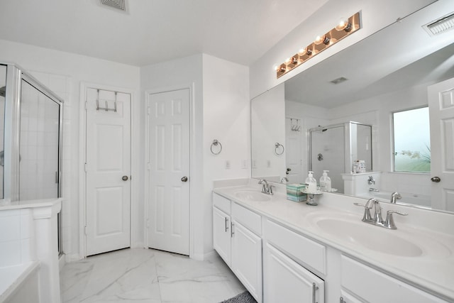 bathroom with visible vents, a sink, a stall shower, and marble finish floor