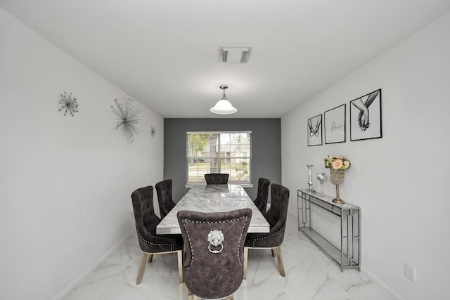 dining area featuring marble finish floor, baseboards, and visible vents
