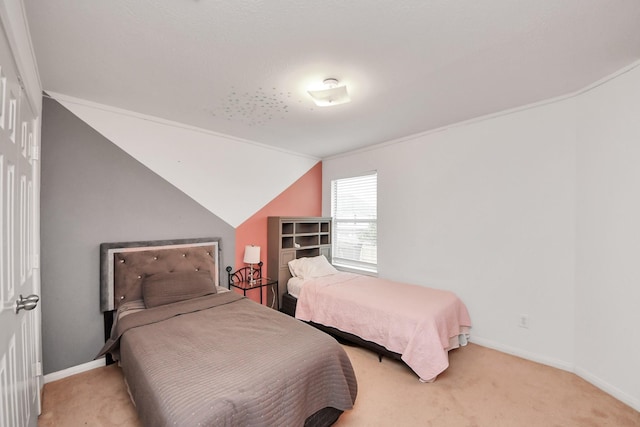 bedroom with vaulted ceiling, baseboards, and light colored carpet